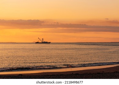 Beautiful Sunset At Caldera Beach In Costa Rica With A Boat In The Water