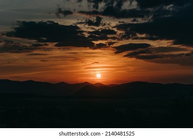 Beautiful Sunset In Carpathian Mountains, Ukraine. Warm Orange Light, Sky, Dark Silhouette. Traveling In Summer. No People.