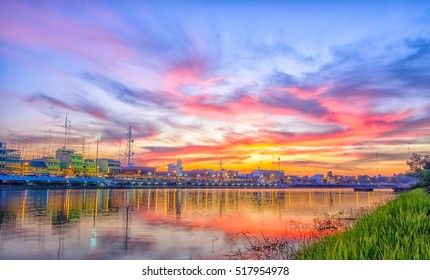 Beautiful Sunset With City Near River.