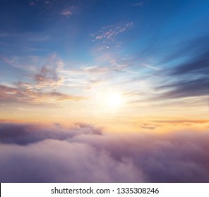 Beautiful Sunset Cloudy Sky From Aerial View. Airplane View Above Clouds