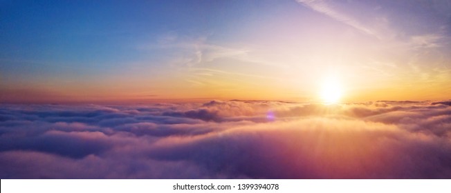 Beautiful sunset cloudy sky from aerial view. Airplane view above clouds - Shutterstock ID 1399394078