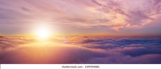 Beautiful Sunset Cloudy Sky From Aerial View. Airplane View Above Clouds