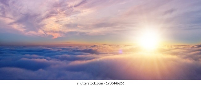 Beautiful sunset cloudy sky from aerial view. Airplane view above clouds