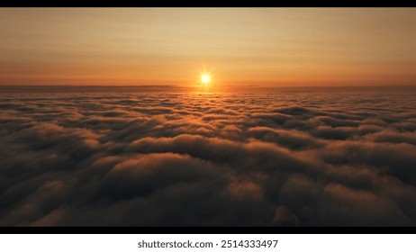 Beautiful sunset cloudy sky from aerial view. Airplane view above clouds .Beautiful sky background - Sunset Sunrise sky with light clouds and real sun - Powered by Shutterstock