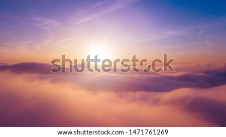 Beautiful sunset cloudy sky from aerial view. Airplane view above clouds