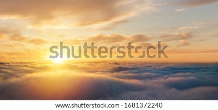 Beautiful sunset cloudy sky from aerial view. Airplane view above clouds