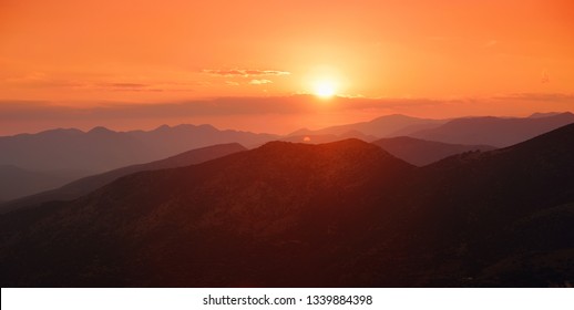 Beautiful sunset colors over the mountains of Peloponnese, Greece. Sun setting after hot summer day. - Powered by Shutterstock