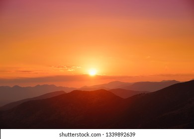 Beautiful sunset colors over the mountains of Peloponnese, Greece. Sun setting after hot summer day.