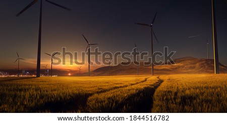 Beautiful sunset field with wind mill generators. big city in background. High quality photo