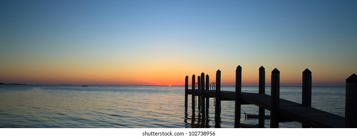 Beautiful Sunset In The Florida Keys With Boat Dock Silhouette.