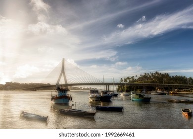 Beautiful Sunset in front of Ilhéus-Pontal Bridge with fishing boats, Ilheus, Bahia, Brazil.