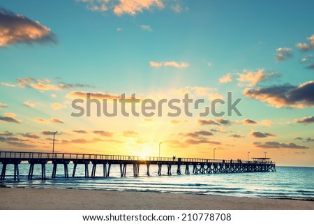 Beautiful sunset at Grange Jetty Adelaide Australia with peoples silhouettes 