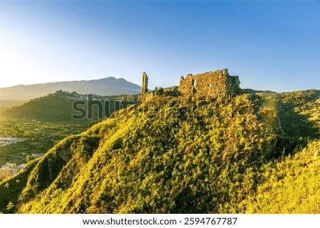 beautiful sunset landscape of ancient Sicilian caslte ruins on the top of a mountain in Italy, Sicily.  Wonderful view of ancient monument with nice evening sky on background