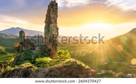 beautiful sunset landscape of ancient Sicilian caslte ruins on the top of a mountain in Italy, Sicily.  Wonderful view of ancient monument with nice evening sky on background