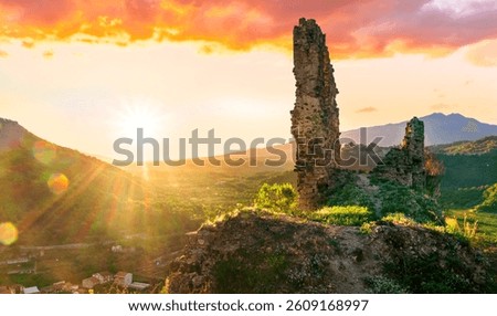 beautiful sunset landscape of ancient Sicilian caslte ruins on the top of a mountain in Italy, Sicily.  Wonderful view of ancient monument with nice evening sky on background