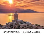 .Beautiful sunset in the lighthouse in Melagavi cape at Loutraki, Greece.
