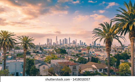 Beautiful sunset of Los Angeles downtown skyline and palm trees - Shutterstock ID 1418018357