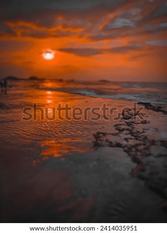 Beautiful sunset at the ocean. A vibrant sky filled with colorful clouds in the eve. Ocean, sunset, nature beauty and coastal concept image. 
