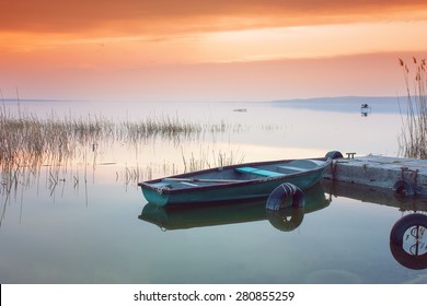 Beautiful sunset on Lake Balaton with anchored boat - Powered by Shutterstock