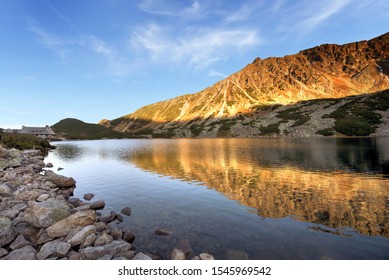 Beautiful sunset on the lake in the mountains. Valley of five Ponds. Tatra National Park in Poland.