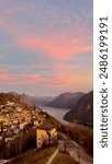 Beautiful sunset on Monte Bre over the mountains and glaciers of Switzerland, a lake and a small village close to Lugano