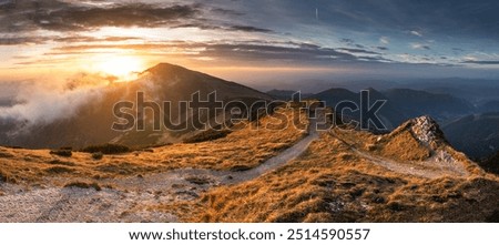 Similar – Image, Stock Photo Sunset in mountains. Natural mountain landscape with illuminated misty peaks, foggy slopes and valleys, blue sky with orange yellow sunlight