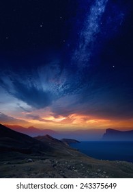 Beautiful Sunset On Mountains And Sea, Glowing Horizon, Bright Galaxy And Stars In Dark Blue Sky. Elements Of This Image Furnished By NASA Nasa.gov