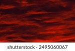 Beautiful sunset with orane and red tons under altocumulus clouds