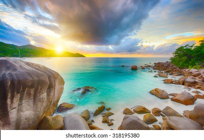 Beautiful sunset over the famous beach Anse Lazio seen from the granite boulders, Praslin island, Seychelles. 