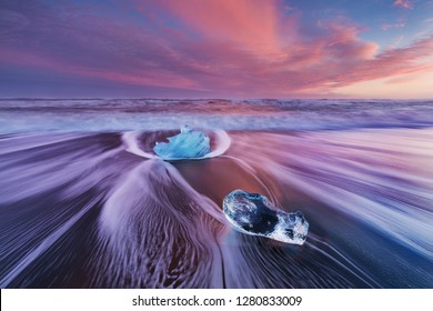 Beautiful sunset over famous Diamond beach, Iceland. This sand lava beach is full of many giant ice gems, placed near glacier lagoon Jokulsarlon
Ice rock with black sand beach in southeast Iceland