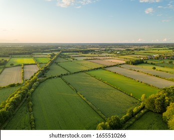 Beautiful Sunset over green fields in germany shot from a ariel view.
