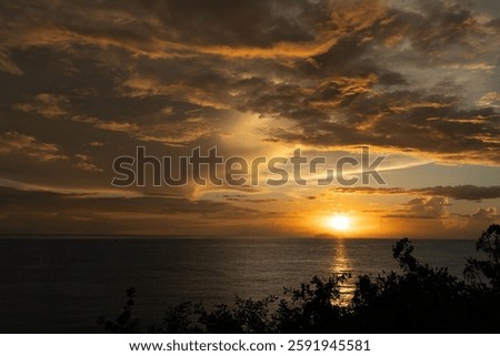 A beautiful sunset over the ocean with dramatic clouds. Rincon, Puerto Rico