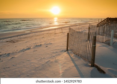 Beautiful Sunset Over the Ocean with Sand Fencing.