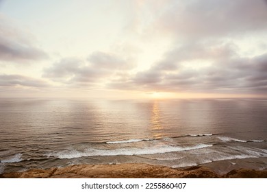 A beautiful sunset over the Pacific Ocean in neutral, brown and sepia tones.