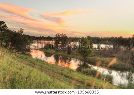 A beautiful sunset over Penrith Lakes near Castlereagh with Blue Mountains in distance.  The area was one of the first rural settlements in Australia and is one of the five Macquarie towns