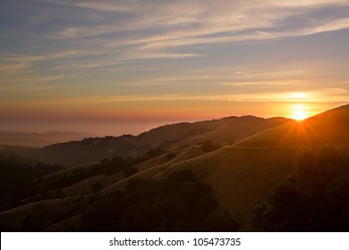 Beautiful sunset over the Santa Cruz Mountains of California with Pacific Ocean in background