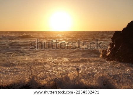 Beautiful sunset over tropical island wavy beach with beautiful golden colours