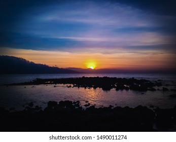 Beautiful Sunset Panorama On Tropical Rocky Fishing Beach In The Evening At Umeanyar Village, North Bali, Indonesia