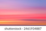 A beautiful sunset with a pink and purple sky. The sky is filled with clouds and the sun is setting. The sky is a mix of pink and purple colors, creating a serene and calming atmosphere