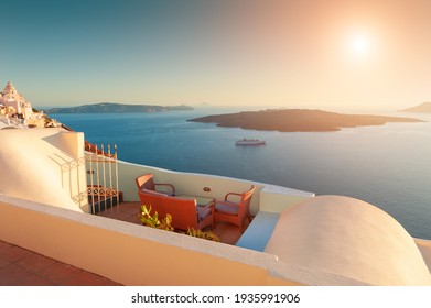 Beautiful Sunset At Santorini Island, Greece. Chairs On The Terrace With Sea View. Travel Destinations Concept