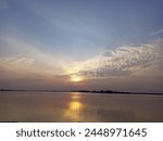 Beautiful sunset seen from the shoreside of Jehlum River, Jhawarian, District Sargodha, Tehsil Shahpur, Punjab, Pakistan. The Jhelum River is a 725 km long river in the northern Indian subcontinent.