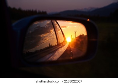 Beautiful Sunset In Sideview Car Mirror On Mountain Road