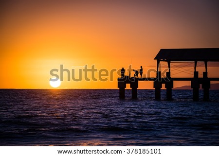 Beautiful sunset silhouetting the Waimea State Recreation Pier on Kauai, Hawaii