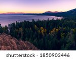 Beautiful sunset skies over Lake Tahoe and the Sierra Nevada Mountains with fall foliage and forest views from Eagle Rock, California.