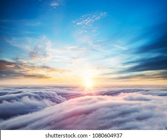 Beautiful Sunset Sky Above Clouds With Dramatic Light. Cabin View From Airplane