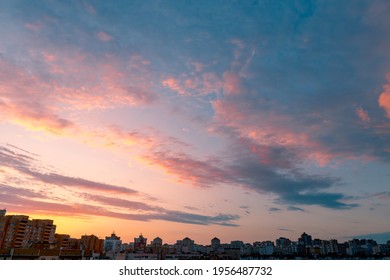 Beautiful sunset sky with clouds. Twilight over urban district. Typical modern residential area. - Powered by Shutterstock