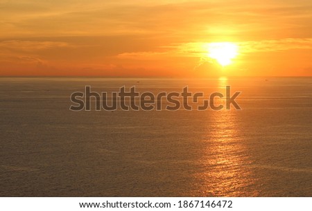 Beautiful sunset with small clouds  on the sky. sun ray and light on the water. sun reflaction in the water.