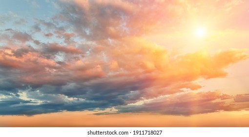 Beautiful sunset or sunrise sky with clouds and sun in the frame, background