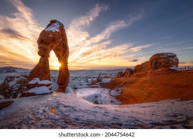 Beautiful sunset time at popular landmark Delicate Arch with snow in the winter season, Arches National Park, Moab, Utah. - Shutterstock ID 2044754642