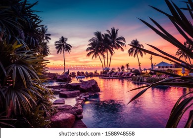 Beautiful Sunset View With Palm Trees Reflecting In Swimming Pool In Luxury Island Resort In Thailand